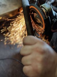 Close-up of man working on metal