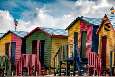 Low angle view of beach huts against sky