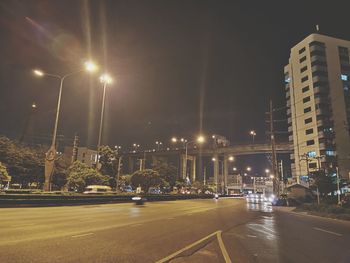 Cars on city street at night