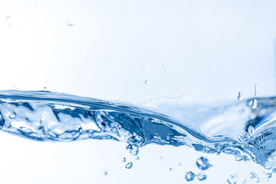 Close-up of water splashing against white background