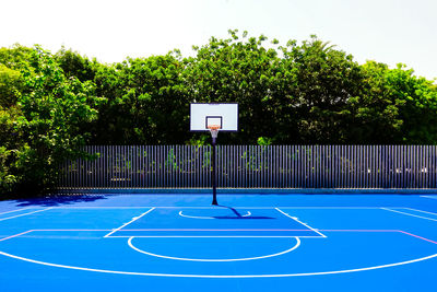 Basketball hoop against blue sky