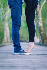 Low section of woman standing on footpath