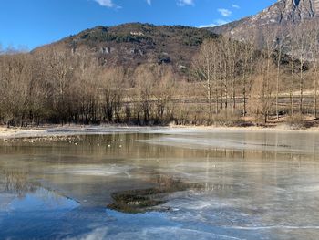 Scenic view of lake against sky during winter
