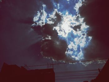 Low angle view of silhouette building against sky