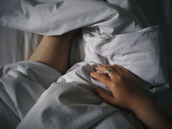 Midsection of woman lying on bed