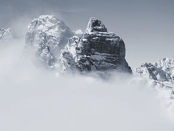 Low angle view of snowcapped mountain against sky