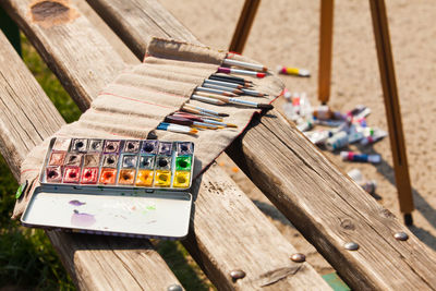 High angle view of paintbrushes on wooden table