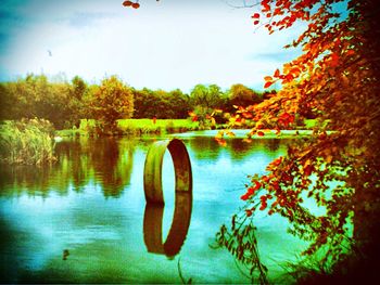 Reflection of trees in lake against sky