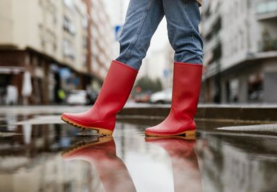 Low section of woman standing on street