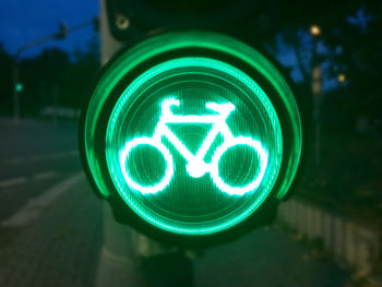 Close-up of road signal at night