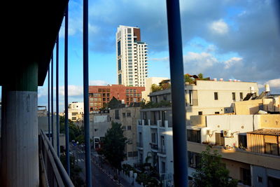 Buildings in city against blue sky