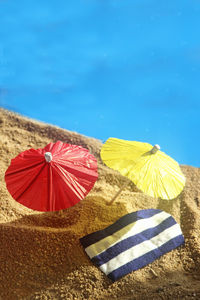 Umbrella on beach against blue sky