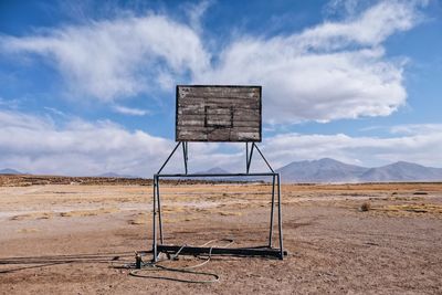 Abandoned basketball hoop on cloudy sky