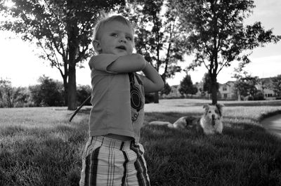 Boy holding stick in park