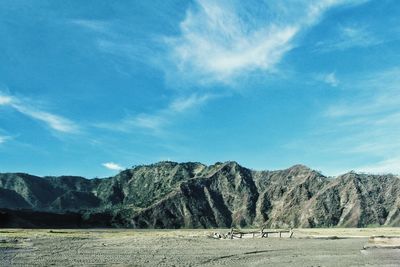 Scenic view of mountains against blue sky