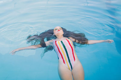 Teen girl having fun in the swimming pool