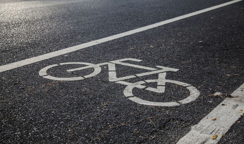 High angle view of arrow symbol on road