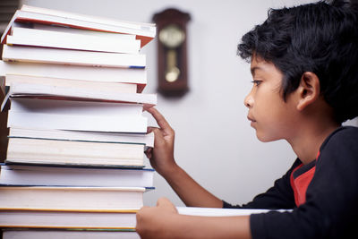 Portrait of boy looking at book