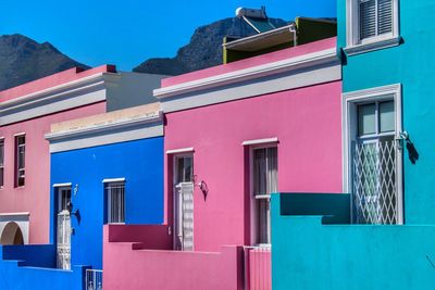 Multi colored residential buildings against blue sky