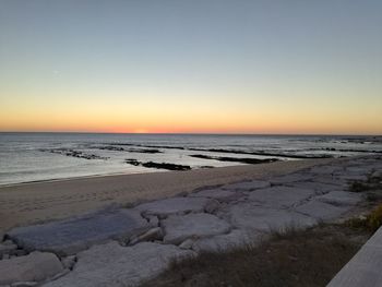 Scenic view of sea against clear sky during sunset