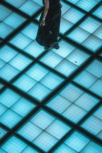 Low section of man standing on tiled floor