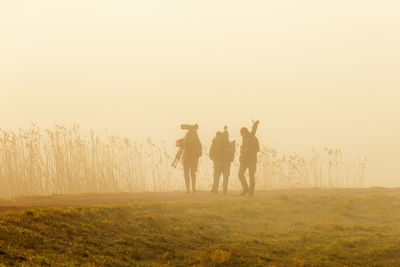 Birdwatchers in the fog an early morning