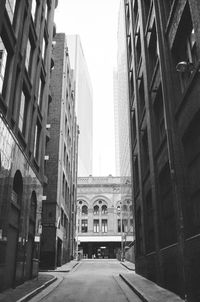 Street amidst buildings against sky in city