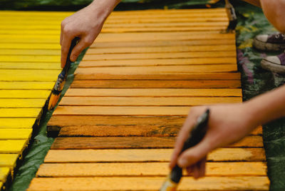 Midsection of man working on wood