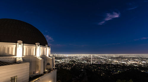 The griffith park observatory sits high in the hills overlooking los angeles.