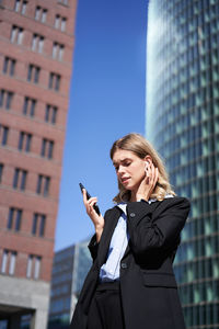 Portrait of young businesswoman using mobile phone