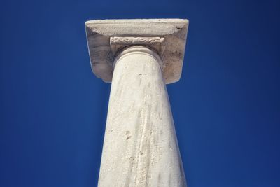 Low angle view of tower against blue sky