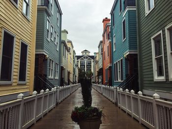 Boardwalk amidst residential buildings against sky