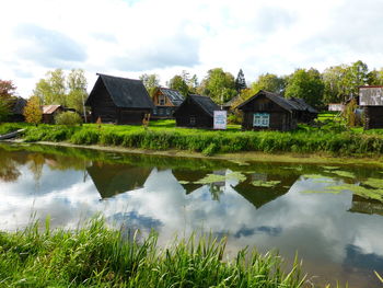 Scenic view of lake and buildings against sky