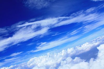 Low angle view of vapor trail in blue sky