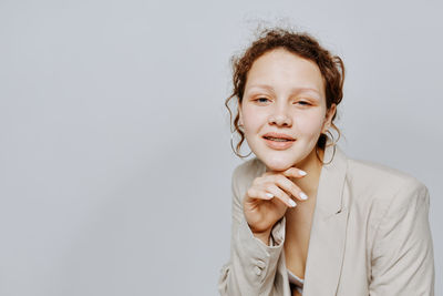 Portrait of teenager girl against white background