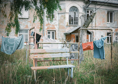Chairs and table in field by building