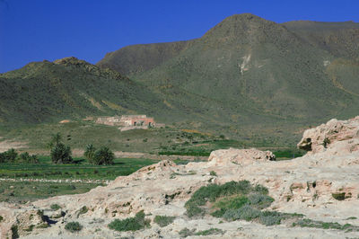 Scenic view of rocky mountains against clear blue sky