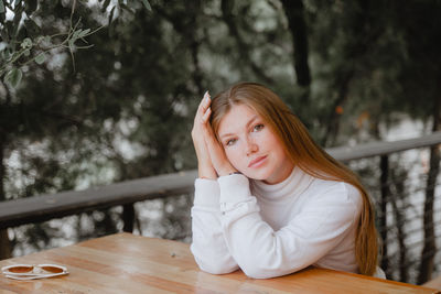 Young woman sitting at table