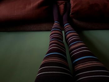 Low section of woman wearing leggings at home
