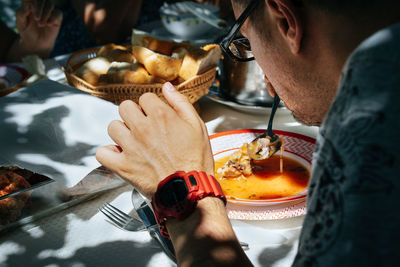 Close-up of man eating food on table in restaurant