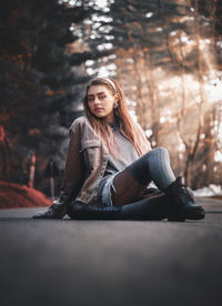 Portrait of young woman sitting outdoors