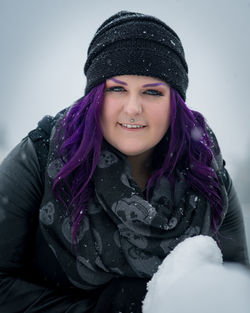 Portrait of a smiling young woman in snow