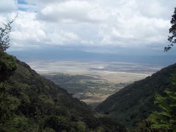 Scenic view of mountains against cloudy sky