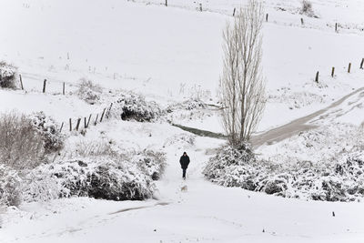 Man walking on snow field during winter