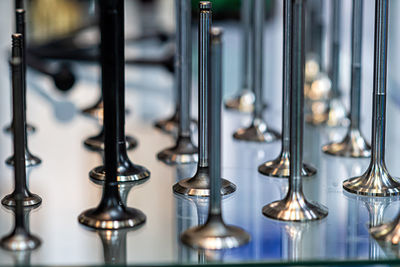 Abstract background with car engine valves in a glass showcase, close-up
