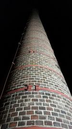 Low angle view of illuminated building against sky at night