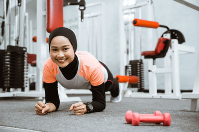 Shirtless athlete exercising in gym