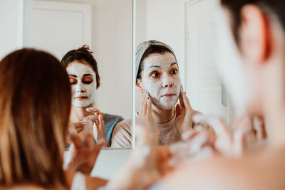 Women applying facial mask