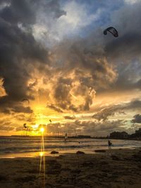 Scenic view of beach against sky during sunset