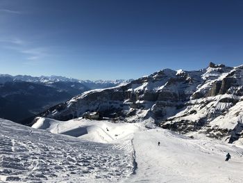 Scenic view of snow covered mountains against sky